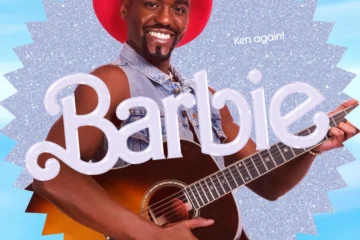 Ncuti in a Barbie advert. he wears a big hat and plays a guitar.