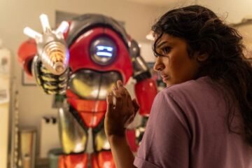 Belinda being held at gunpoint by a robot